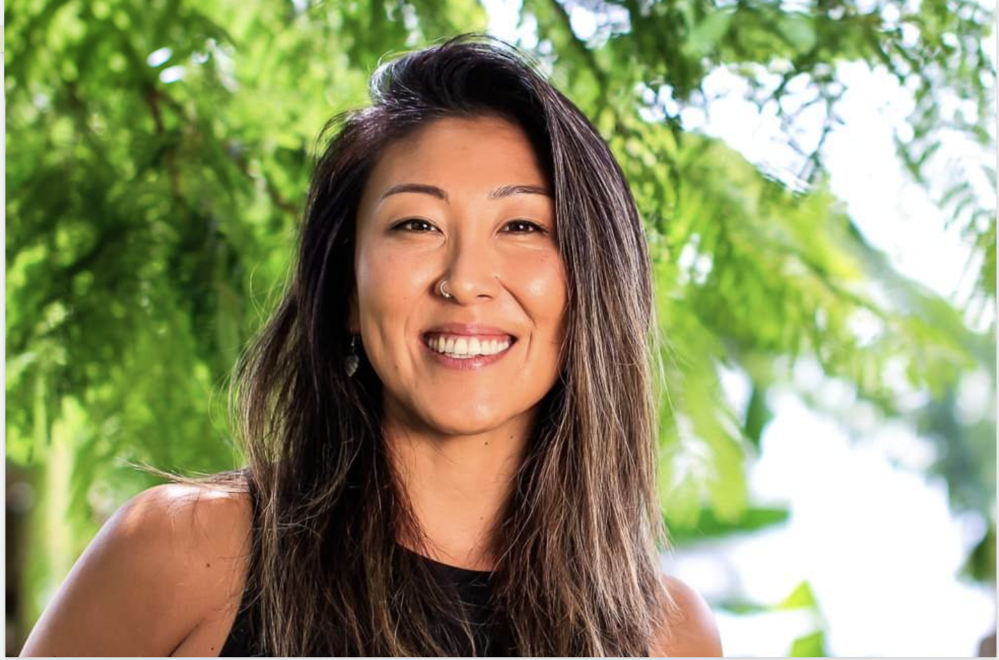 Laini, founder of Simply U Yoga & Pilates, smiling outdoors